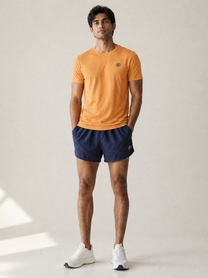 Athleia Sprintlite Shorts Navy with Pro Tee Orange – worn by a man