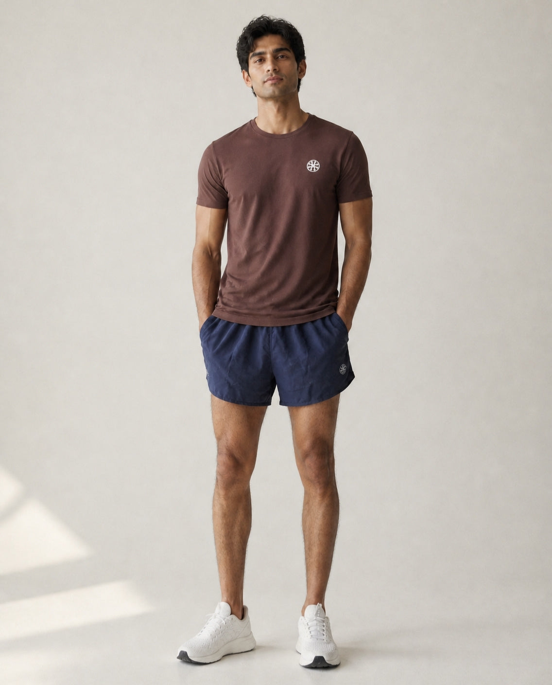 Athleia Sprintlite Shorts Navy with Pro Tee Brown – worn by a man