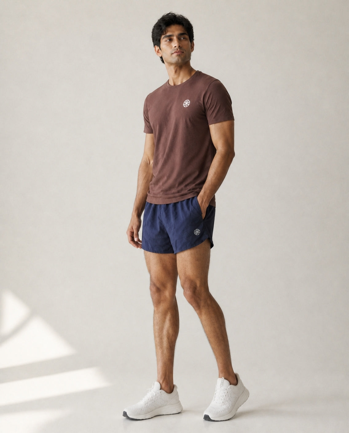 Athleia Sprintlite Shorts Navy with Pro Tee Brown, side view – worn by a man