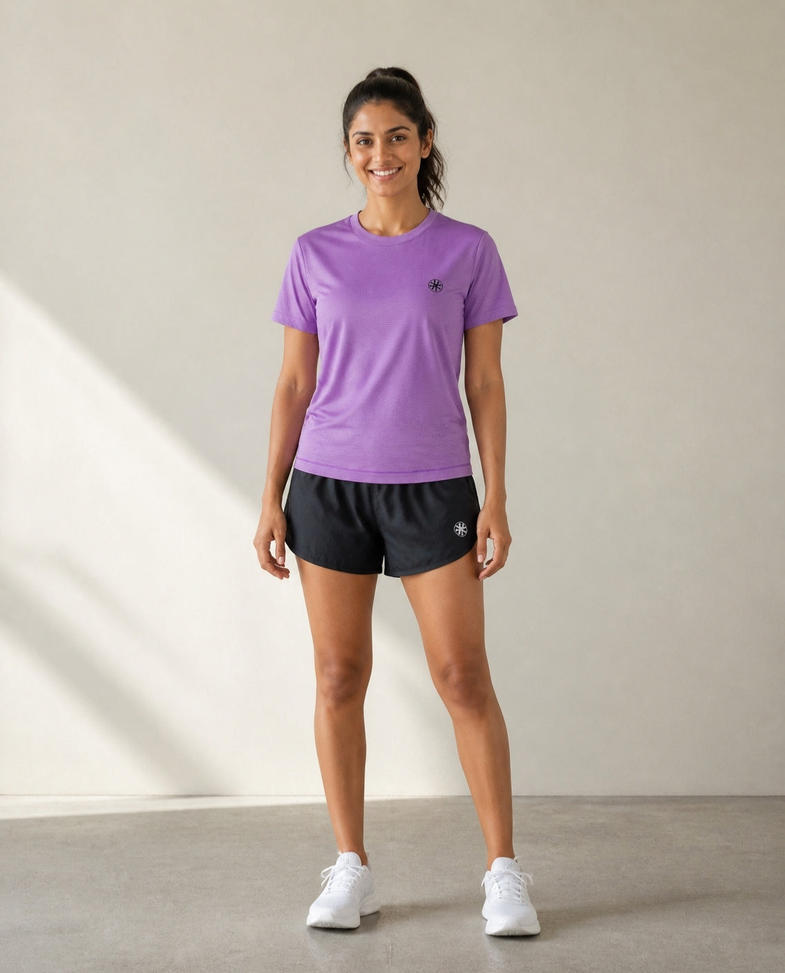 Athleia Sprintlite Shorts Black with Breathe Top Lilac – worn by a woman