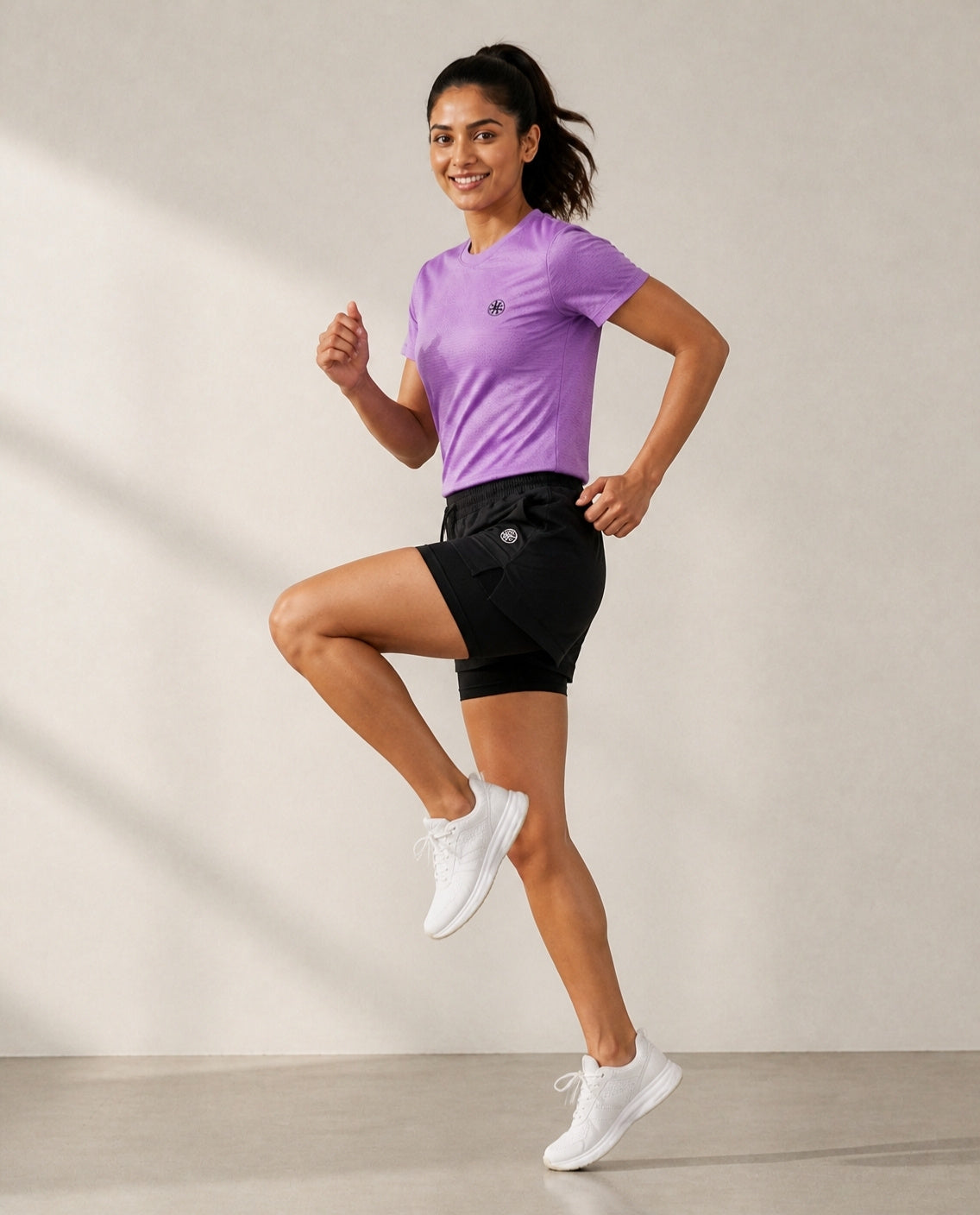 Athleia Aeroform Lined Shorts with Breathe Top Lilac, side view – worn by a woman