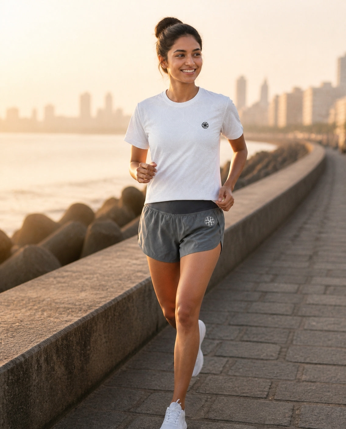 Athleia Arc Mini Shorts with Breathe Top Silver, Marine Drive run – worn by a woman