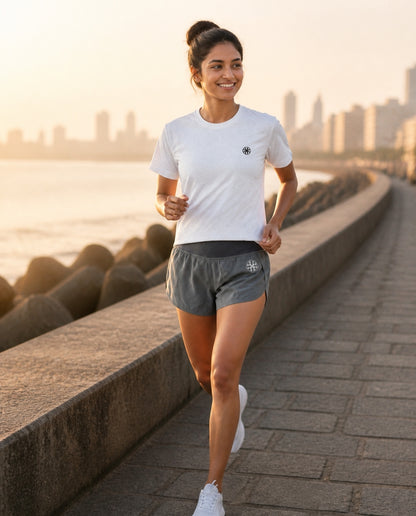 Athleia Arc Mini Shorts with Breathe Top Silver, Marine Drive run – worn by a woman