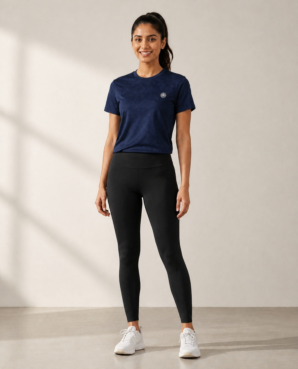 Athleia Seamless Jacquard Dark Blue with Infinite Leggings Black – worn by a woman