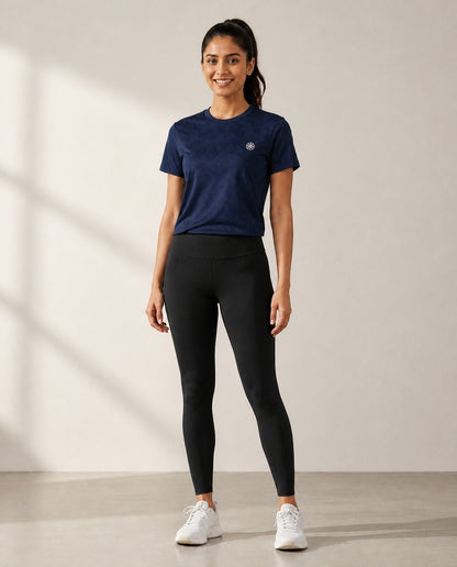 Athleia Seamless Jacquard Dark Blue with Infinite Leggings Black – worn by a woman