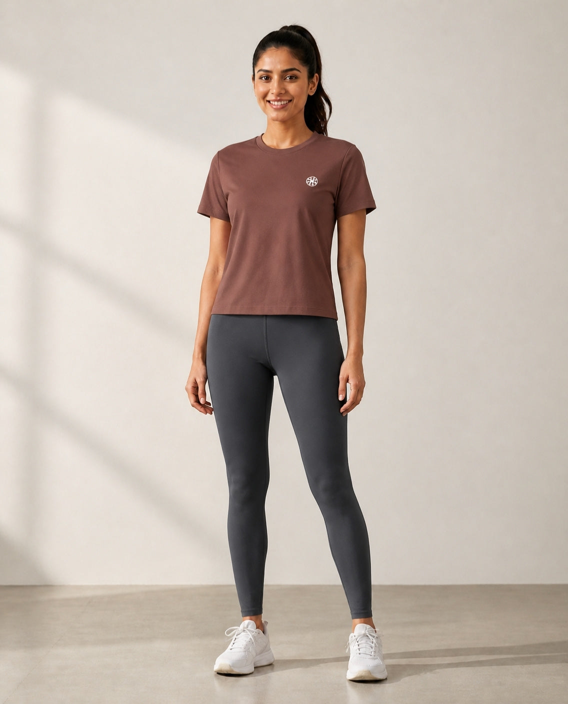 Athleia Pro Tee Brown with Infinite Leggings Graphite – worn by a woman