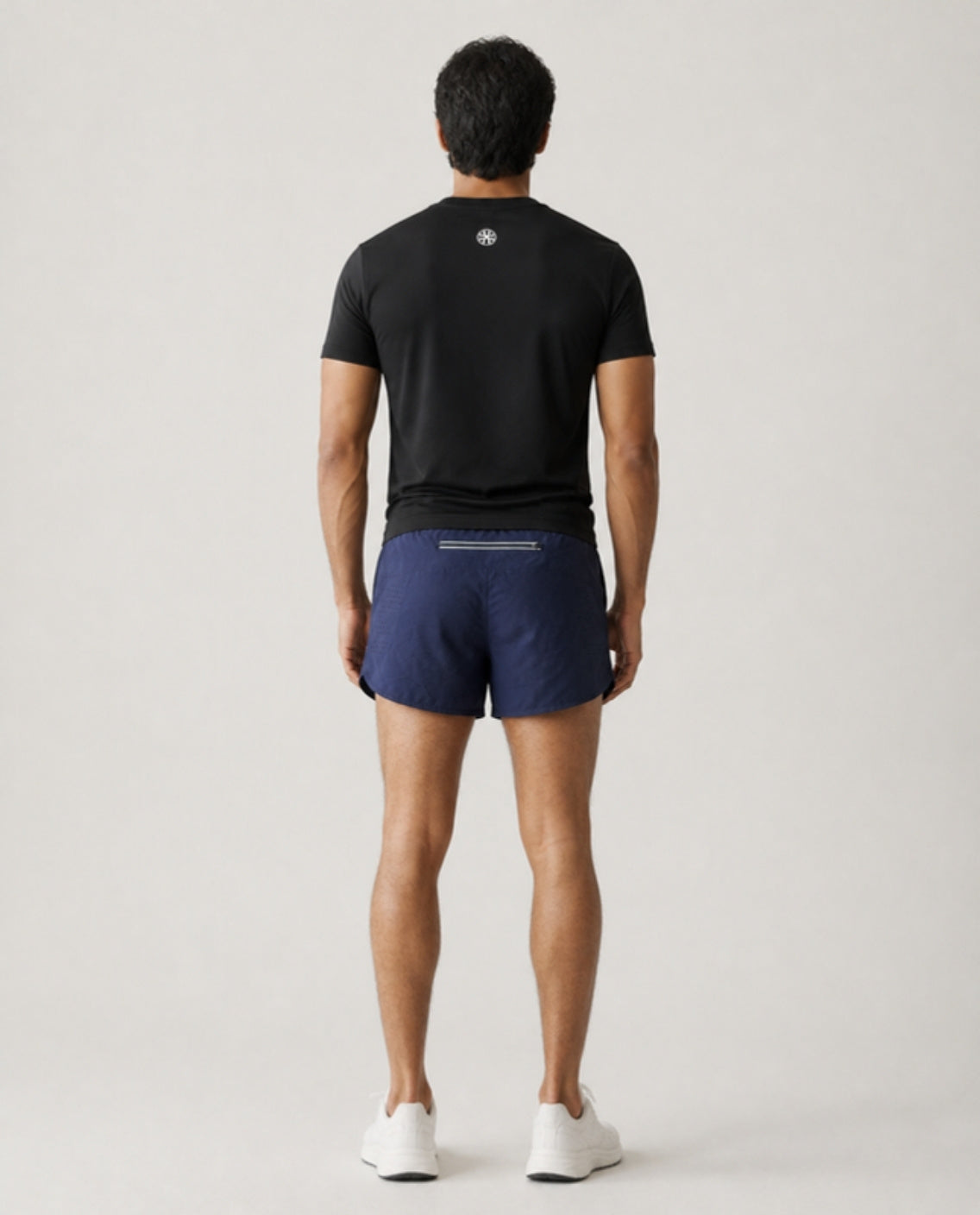 Athleia catalogue shoot – sprintlite shorts navy – back – worn by a man